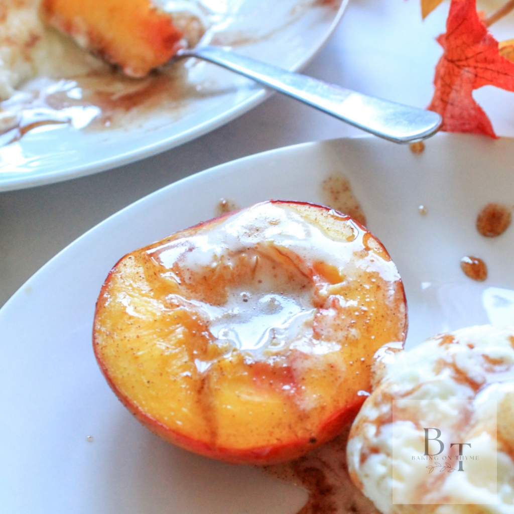two white plates with baked nectarine and ice cream