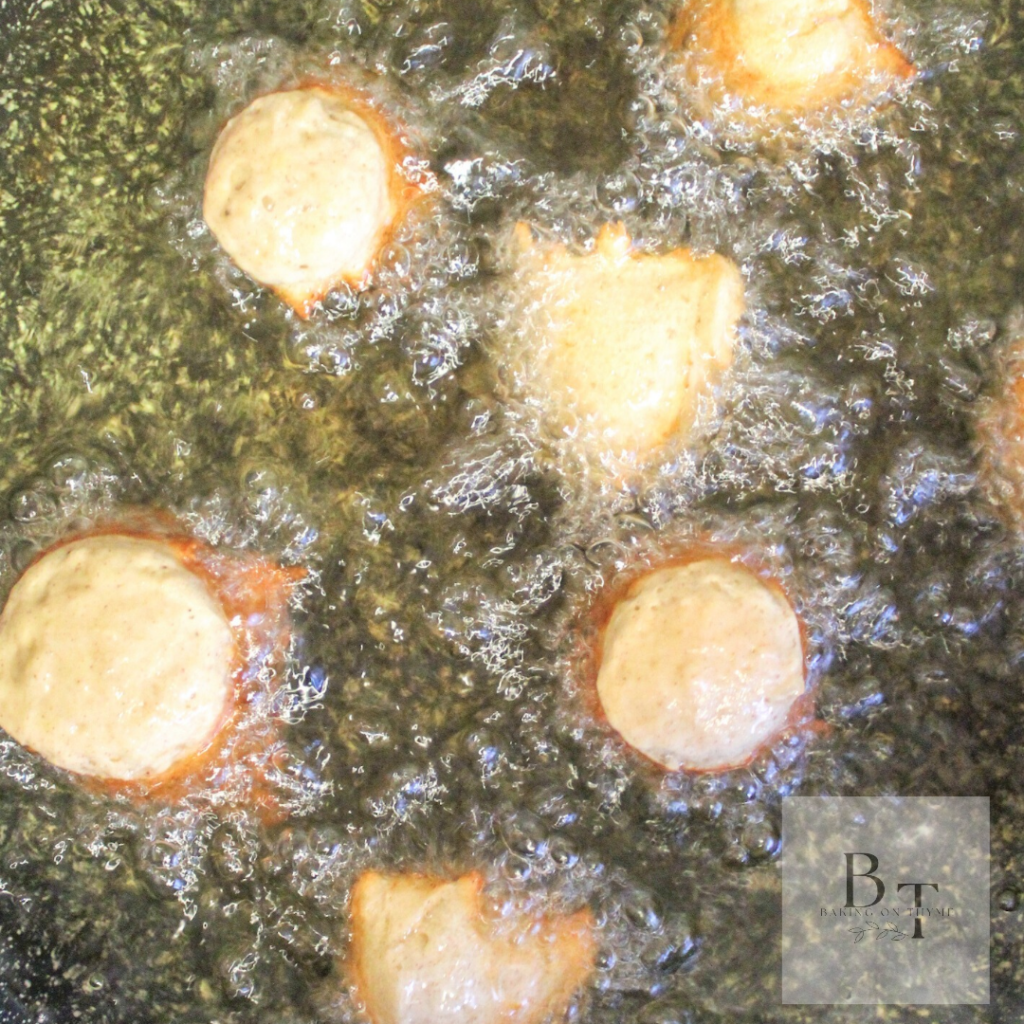 deep frying the Homemade Banana Gulgula aka Indian banana fritters in a hot pot of vegetable oil
