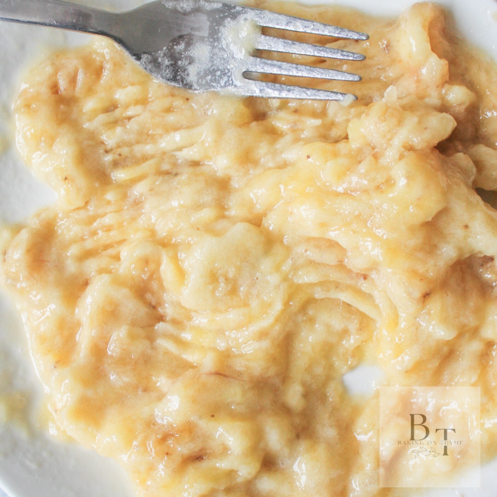 plate of mashed banana being prepared for Homemade Banana Gulgula batter