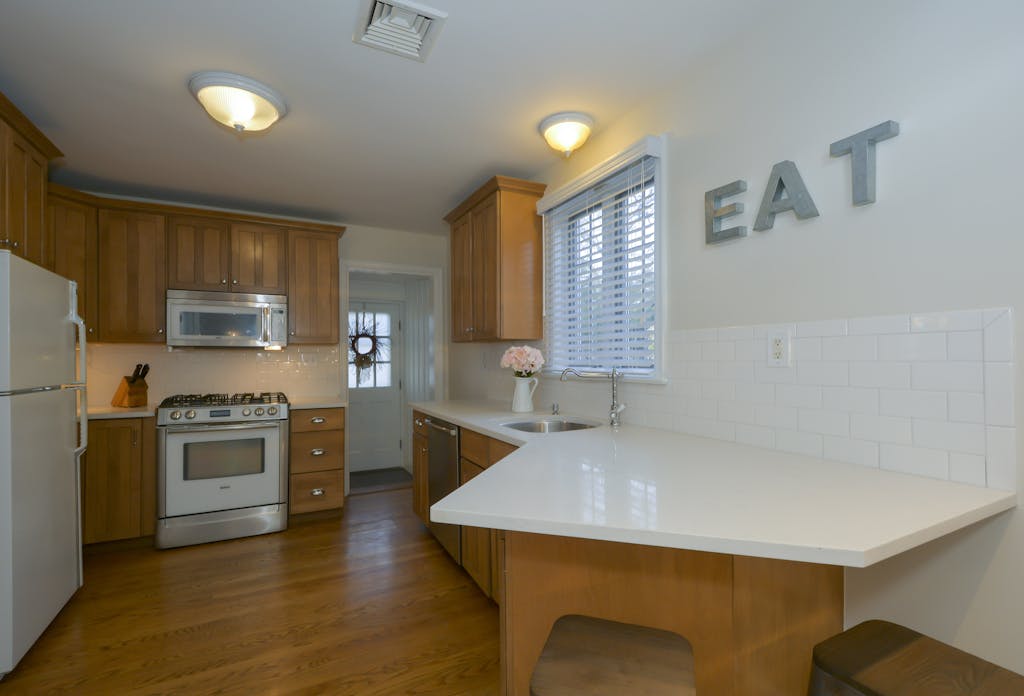A clean, modern kitchen interior featuring wooden cabinets and a white countertop.
lessons ive learned in the kitchen