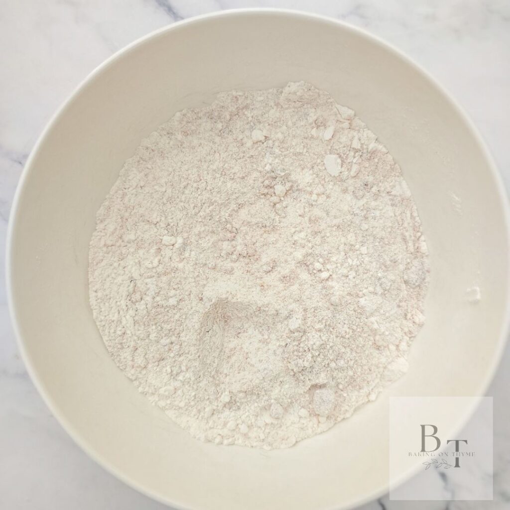 Dry ingredients for pumpkin bread - flour, baking soda, baking powder, salt, cinnamon, nutmeg, and cloves.